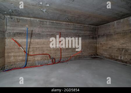 Empty basement room with minimal preparatory repairs. interior with white brick walls Stock Photo