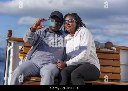 Happy couple taking selfie picture with a mobile phone camera. Stock Photo
