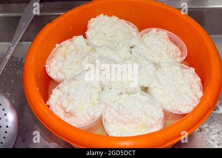 phases of ricotta production in a cheese factory in Greece Stock Photo