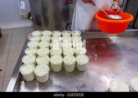 phases of ricotta production in a cheese factory in Greece Stock Photo