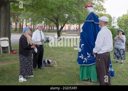 Devout Roman Catholics pray at a service near the Vatican Pavilion site in Flushing Meadows park where Mary & Jesus appeared to Veronica Lueken. NYC Stock Photo