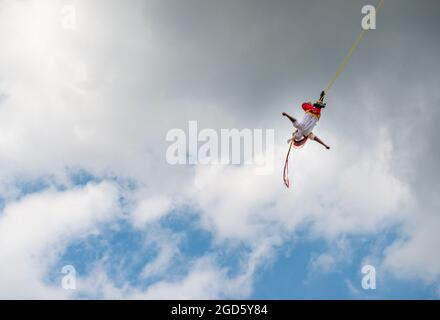 Papantla, Mexico - May 21, 2014: A volador (flying dancer) performing the traditional Danza de los Voladores (Dance of the Flyers) in Papantla, Mexico Stock Photo