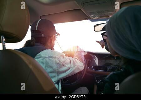 asian couple looking at view while traveling by car Stock Photo