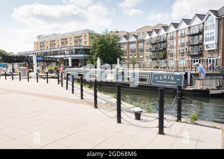 A narrowboat maneuvering Brentford Gauging Locks on the River Brent