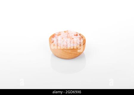 Himalayan salt, pink himalayan salt. himalayan salt in wooden bowl,  on white background Stock Photo