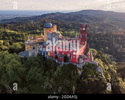 Aerial view of Pena Palace, a colorful castle building on hilltop at sunset, Lisbon, Portugal Stock Photo