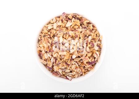 chopped scallion. chopped scallion in white bowl on white background. chopped scallion, dried Shallots Flakes, dry onion, onion flakes. macro shot Stock Photo