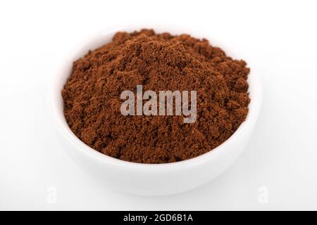 ground  turkish coffee. ground turkish coffee in white bowl on white background. macro shot turkish coffee Stock Photo