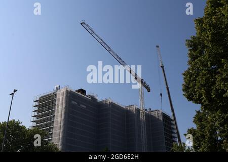 Building under renovation with roofs and cranes, Italy Stock Photo