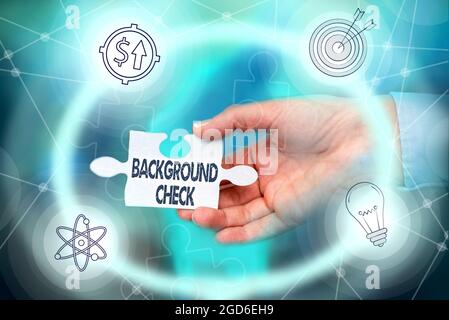 Writing displaying text Background Check. Word for investigation into a person s is origins and previous history Hand Holding Jigsaw Puzzle Piece Stock Photo