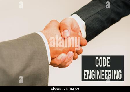 Writing displaying text Code Engineering. Business overview application of engineering to the development of software Two Professional Well-Dressed Stock Photo