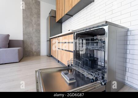 modern Half open empty dishwasher in a modern kitchen Stock Photo