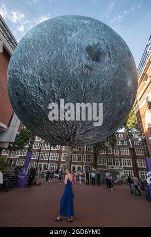 London UK 11 Aug 2021 An incredible lunar installation was unveiled as part of the Kensington   Chelsea Festival .Museum of the Moon is a touring artwork by UK artist Luke Jerram. Measuring seven metres in diameter, the moon features 120dpi detailed NASA imagery of the lunar surface. The optimum time to enjoy this lunar experience is at 7pm when it will come alive with music created by BAFTA and Ivor Novello award winning composer Dan Jones. Credit: Paul Quezada-Neiman/Alamy Live News Stock Photo