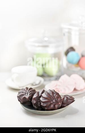 Chocolate covered marshmallows, traditional russian zephyr in chocolate on a light table. selective focus Stock Photo