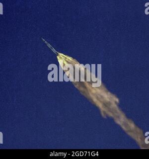 The Sauturn V rocket in flight, nearing space in a clear blue sky with a huge tail of flames,  from Cape Canaveral in Florida. This is mission Apollo 10 which went to the moon but did not land. This mission was a full practice for the moon landing trip Apollo 11. It launched on 18 May 1969 Stock Photo