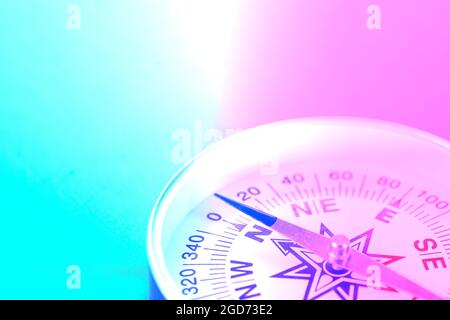 Travel compass close up in neon light. Stock Photo