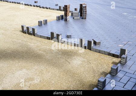 laying of modern beautiful design cobblestones on a flat prepared surface Stock Photo