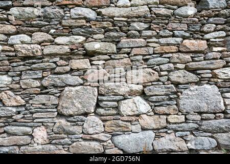 Different sizes of stone blocks in a wall. Stock Photo