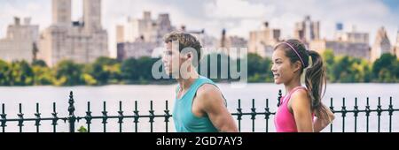 Running couple runners jogging in Central Park, NYC healthy fit city lifestyle. People running summer training for marathon in Manhattan, New York Stock Photo