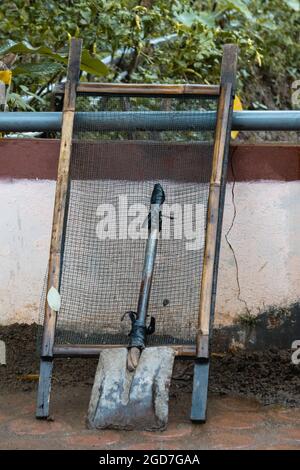 Shovel and sieve after use for gardening and it's rain Stock Photo