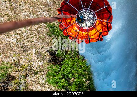 A Bambi bucket device hangs from a U.S. Army CH-47 Chinook helicopter assigned to Joint Task Force-Bravo, 1st Battalion, 228th Aviation Regiment near Soto Cano Air Base, Honduras, April 8, 2021. This bucket is designed to hold up to 2,000 gallons of water which is released by the helicopter crew for aerial firefighting. The routine air to ground firefighting interoperability training was conducted in order to enhance readiness, strengthen partner nation response capabilities and enhance their ability to respond to crises throughout Central America. (U.S. Marine Corps photo by Sgt. Lauren Brune