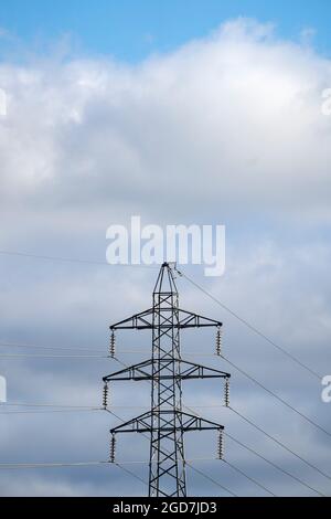 Electrical power pylon on cloudy blue sky Stock Photo