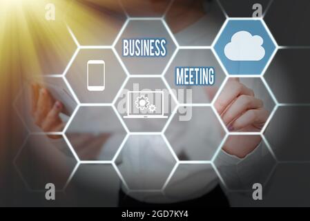 Conceptual caption Business Meeting. Business showcase gathering of two or more showing to discuss business ideas Lady Holding Tablet Pressing On Stock Photo
