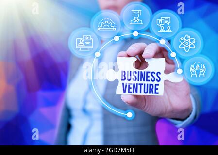 Sign displaying Business Venture. Word Written on new business that is formed with a plan and expect gain Business Woman Holding Jigsaw Puzzle Piece Stock Photo