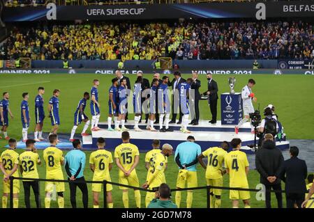 Chelsea players collect their winner's medals from UEFA President Aleksander Ceferin as the Villarreal players look on after the UEFA Super Cup match at Windsor Park, Belfast. Picture date: Wednesday August 11, 2021. Stock Photo