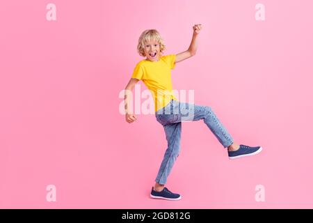 Full body profile side photo of young cheerful small boy happy positive smile go have fun isolated over pink color background Stock Photo