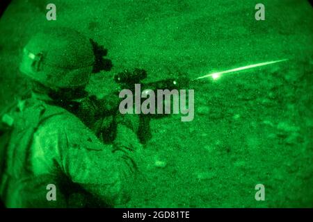 A U.S. Marine with 2nd Battalion, 1st Marines, assigned to Special Purpose Marine Air-Ground Task Force – Crisis Response – Central Command (SPMAGTF-CR-CC) fires his M27 infantry automatic rifle as part of a live-fire and maneuver range in Jordan, May 22, 2021. SPMAGTF-CR-CC is designed to respond rapidly and efficiently to a wide-range of military operations utilizing aviation, ground, and logistics assets. (U.S. Marine Corps photo by Cpl. Jacob Yost) Stock Photo