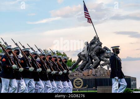 Marines with the Silent Drill Platoon march for “Pass in Review” during a Tuesday Sunset Parade at the Marine Corps War Memorial, Arlington, Va., June 8, 2021. The hosting official for the evening was Mr. Robert D. Hogue, counsel for the Commandant of the Marine Corps, and The Honorable Kirsten E. Gillibrand, U.S. Senator for New York, was the guest of honor. (U.S. Marine Corps photo by Sgt. Jason Kolela) Stock Photo
