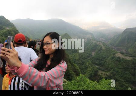 KEDIRI, INDONESIA - March 25, 2016: Tourists enjoying the scenery at the Mount Kelud tourist site Stock Photo