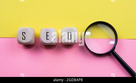 Search Engine Optimization ranking concept, abbreviation SEO on the wooden dice as an idea of promote traffic to website. Selective focus on wooden di Stock Photo