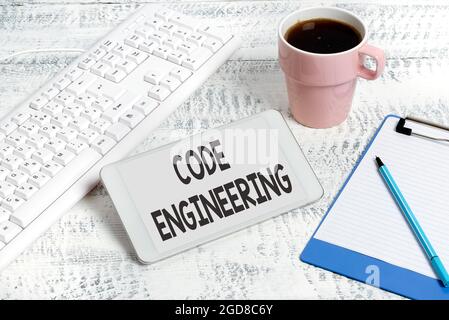 Hand writing sign Code Engineering. Business approach application of engineering to the development of software Wireless Communications Voice And Stock Photo