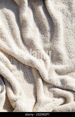 grey towel texture with deep shadow. soft cotton towel backdrop, fabric background. Terry cloth bath or beach towels. Soft fluffy Textile Stock Photo