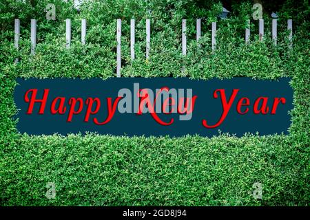 Happy new year texts logo on the framed by green leaves, use happy new year concept. Stock Photo