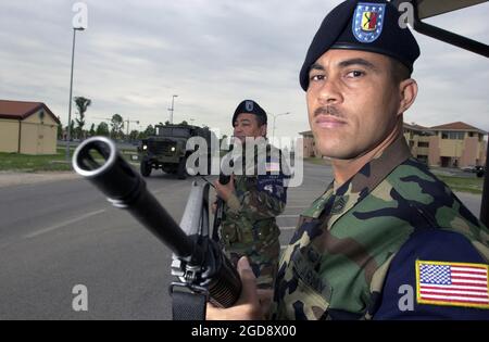 US Army (USA) Specialist Fourth Class (SPC) Julio Centeno, left and Sergeant First Class (SFC) Ernesto Benitez, with the A2 Battalion, 152nd Field Artillery, USA National Guard, Camp Santiago Salinas, Puerto Rico, deployed to Aviano Air Base (AB), Italy, vigilantly stands guard as a 603rd Air Control Squadron (ACS), convoy departs in support of Operation Scorpion Strike.  (USAF PHOTO BY A1C ISAAC G.L. FREEMAN 030714-F-1443F-009) Stock Photo