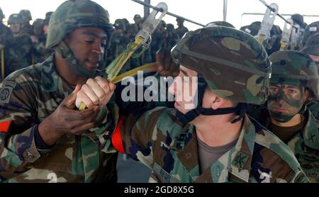 US Army (USA) members from the 82nd Airborne Division (AD), Fort Bragg, North Carolina (NC), practice their jumping procedures before their parachute jump during exercise Large Package Week at Pope Air Force Base (AFB), NC. Large Package week is a joint exercise between the US Air Force and the USA, designed to enhance interservice cohesiveness. (USAF PHOTO BY SSGT SARAYUTH PINTHONG 031202-F-6335P-031) Stock Photo