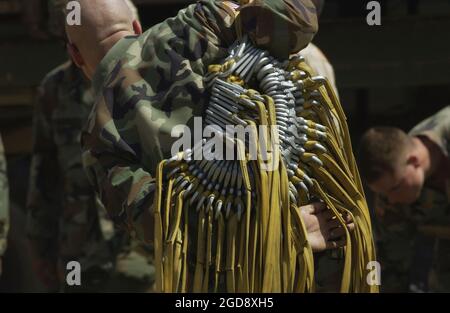 US Army (USA) Specialist (SPC) Daryl Appling, with the 82nd Airborne  Division (AD), 1st Battalion, Support and Transportation Platoon, Fort  Bragg, North Carolina (NC), carries a group of universal static line snap  hooks for parachutes, in support of Joint