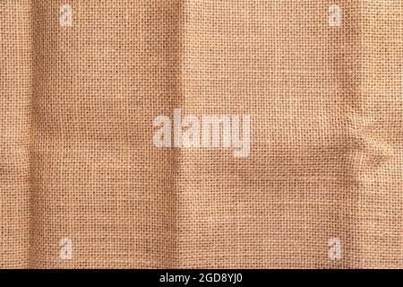 Texture of old crumpled sackcloth burlap with a folds. Close up Stock Photo