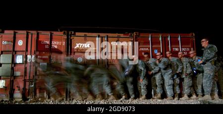 US Army (USA) Soldiers, Charlie Company (C Co), 1st Battalion (BN), 17th Infantry Regiment (1/17th), 172nd Stryker Brigade Combat Team (SBCT), practice stacking and entering a house before they join in an early morning combined air and ground assault with Iraqi Army (IA) Soldiers, 2nd BN, 2nd Brigade, 2nd Division, against suspected Iraqi Insurgent safe houses in Mosul, Ninawa Province, Iraq (IRQ), during Operation IRAQI FREEDOM.  (USAF PHOTO BY TSGT JEREMY LOCK 060617-F-1644L-004) Stock Photo