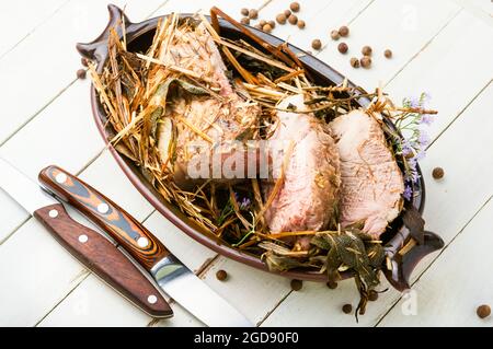 Meat braised in fresh hay.Roasted pork loin in hays.Roasted pork tenderloin Stock Photo