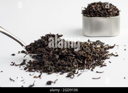 Dried Assam tea leaves on a white background. Stock Photo