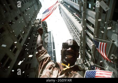 U.S. Army Private First Class White waves an American flag while the confetti and ticker tape paper fall on the Welcome Home parade honoring the coalition forces of Desert Storm.  (USAF PHOTO BY SSGT CHARLES REGER DF-ST-93-02549) Stock Photo