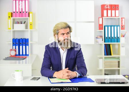 concentrated on work. erp consultant making notes. company executive working with documents. mature man in jacket hold office folder. business Stock Photo