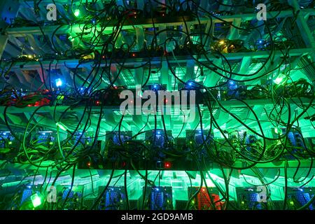 Bitcoin miners in large farm. ASIC mining equipment on stand racks mine ...