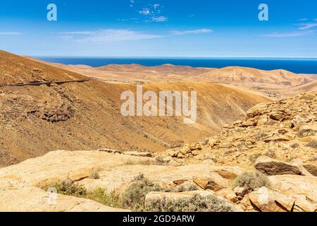 Blue ocean and volcanic landscape from Mirador del Risco de las Penas viewpoint, Pajara, Fuerteventura, Canary Islands, Spain Stock Photo