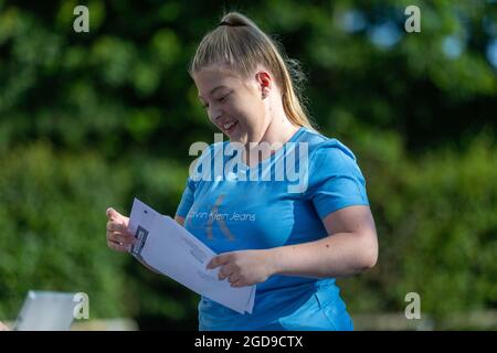 Bromsgrove, Worcs, UK. 12th Aug, 2021. A student gets her GCSE results envelope at North Bromsgrove High Shool in Bromsgrove, Worcestershire. Credit: Peter Lopeman/Alamy Live News Stock Photo