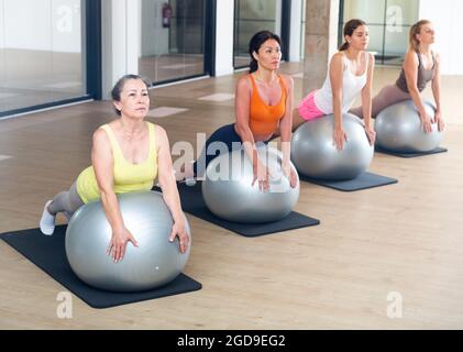 Women of various ages in upward-facing dog Stock Photo